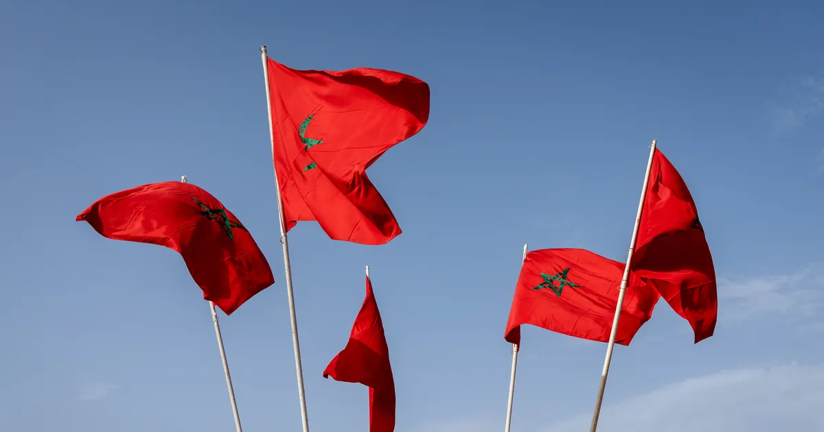 Morocco Independence Day: Moroccan flags waving against a blue sky in Marrakech